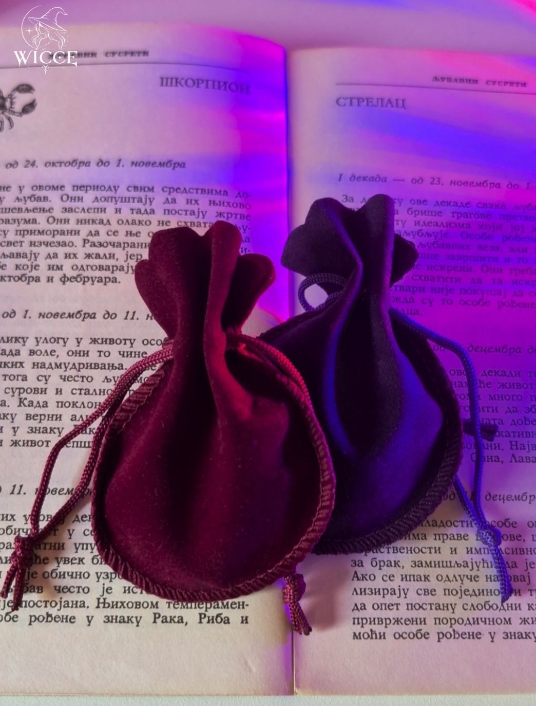 Traditional Slavic Amulet with Raskovnik in red and purple velvet pouches displayed on an old book.