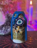 Evil Eye Shield Spell Jar for Warding Off Envy, Jealousy & Malice with blue wax, crystals, herbs and an evil eye charm.