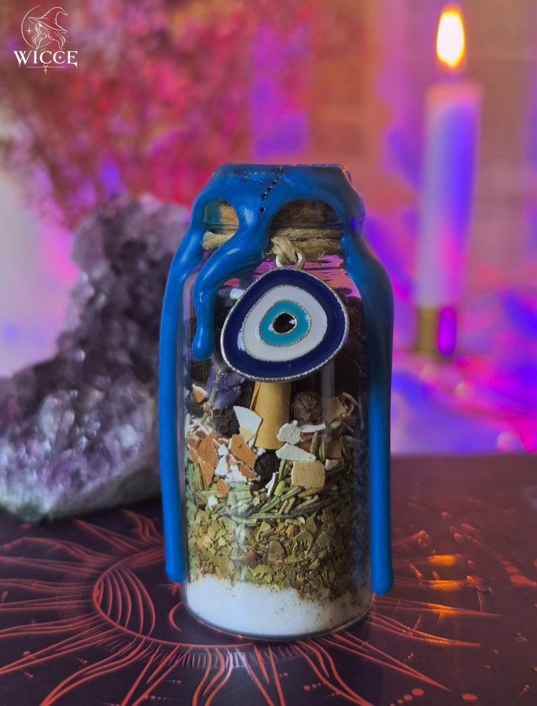 Evil Eye Shield Spell Jar for Warding Off Envy, Jealousy & Malice with blue wax, crystals, herbs and an evil eye charm.