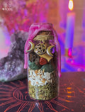Fertility Spell Jar for Pregnancy & Motherhood with pink wax, egg shell, jasper, green aventurine, herbs, and a pentagram charm.