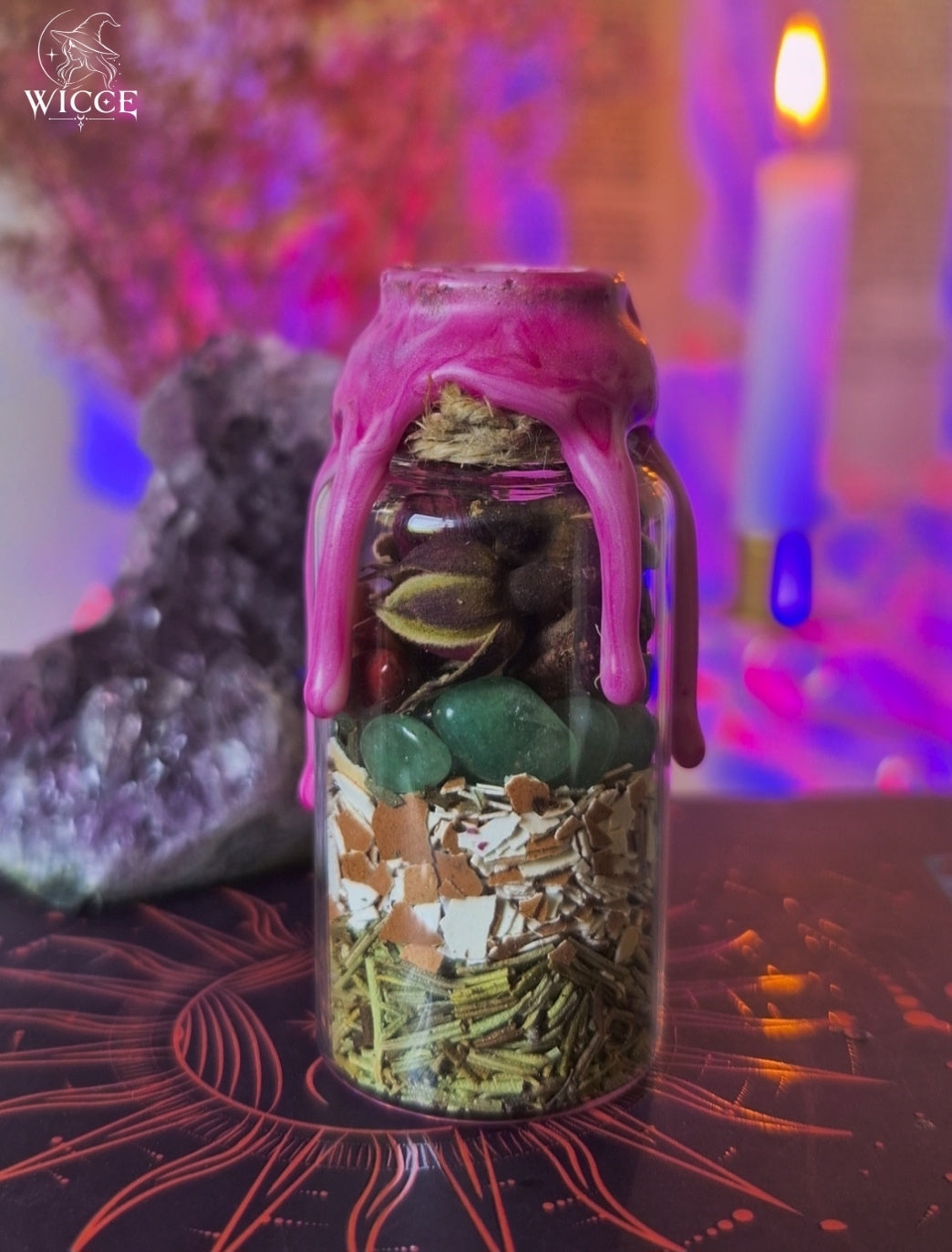 Fertility Spell Jar for Pregnancy & Motherhood viewed from the back, showing rose, green aventirine, egg shell, dried herbs and botanical ingredients inside the glass jar.