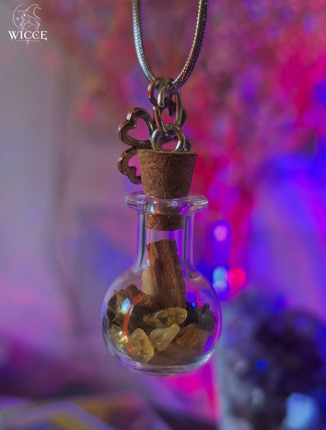 Money Magnet talisman necklace with a clover charm, glass vial filled with cinnamon, citrine and herbs.