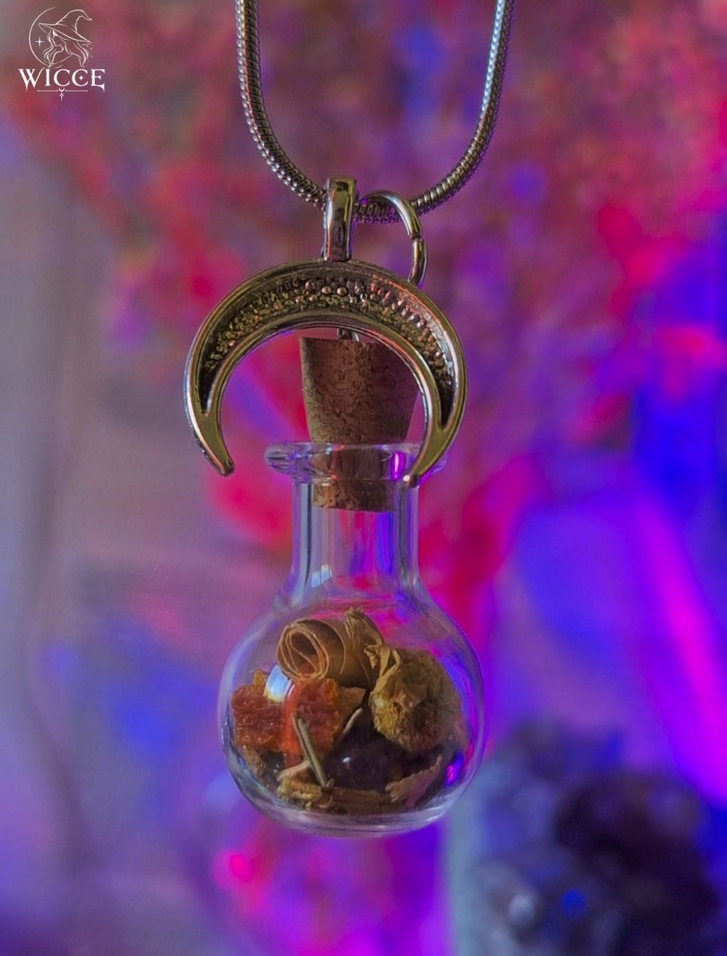 New Beginnings talisman necklace with a crescent moon charm, glass vial filled with herbs and amethyst.