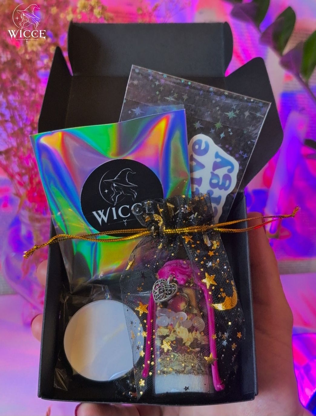 WICCE spell jar gift packaging with a candle, spell jar, gift, crystals, pouch, stickers in black box.